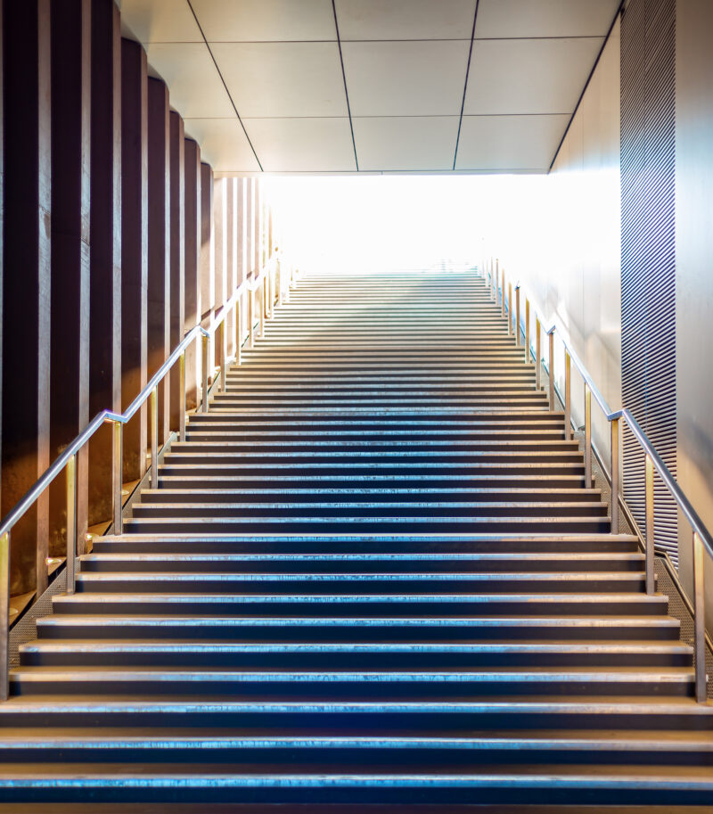 Illuminated stairs coming from underground pedestrian passage leading into the light